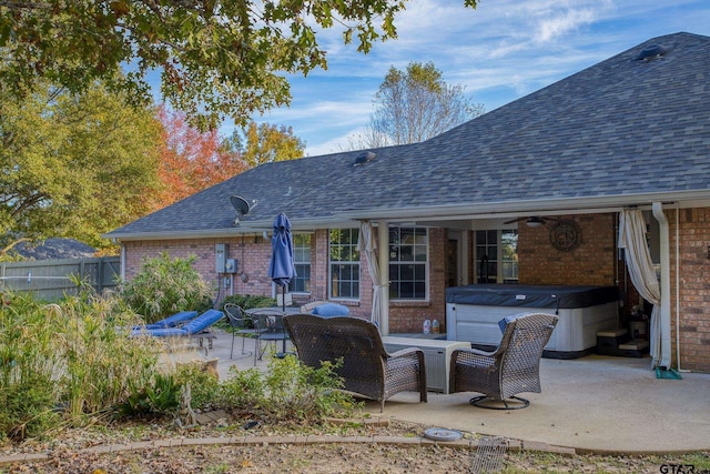 back of property featuring a patio, a hot tub, and ceiling fan