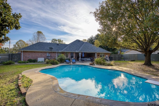 view of swimming pool featuring a lawn and a patio area