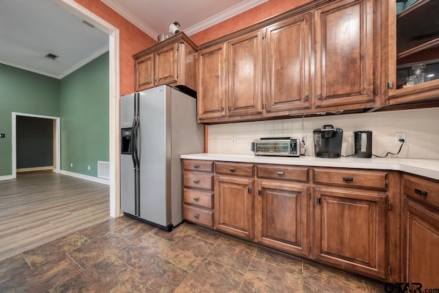 3606 Brookview Ct, Tyler, TX 75707 - kitchen with stainless steel fridge with ice dispenser, crown molding, decorative backsplash, light countertops, and brown cabinets