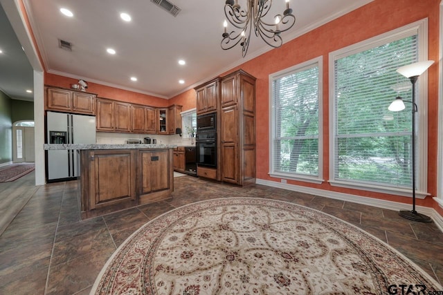 3606 Brookview Ct, Tyler, TX 75707 - kitchen with black appliances, stone tile flooring, brown cabinets, crown molding, and a kitchen island