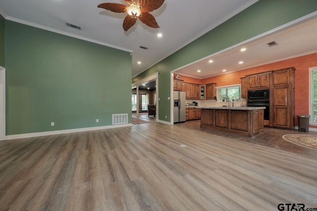 3606 Brookview Ct, Tyler, TX 75707 - unfurnished living room featuring ornamental molding, healthy amount of natural light, a ceiling fan, wood finished floors, and recessed lighting