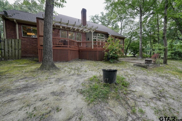 3606 Brookview Ct, Tyler, TX 75707 - rear view of property featuring a pergola, a wooden deck, brick siding, and a chimney