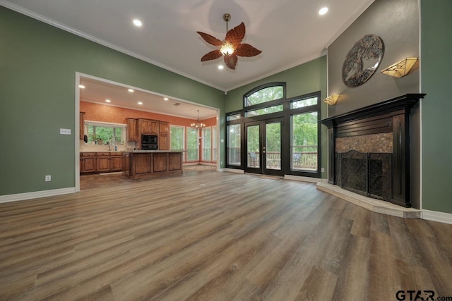 3606 Brookview Ct, Tyler, TX 75707 - unfurnished living room featuring a stone fireplace, a ceiling fan, recessed lighting, wood finished floors, and ornamental molding
