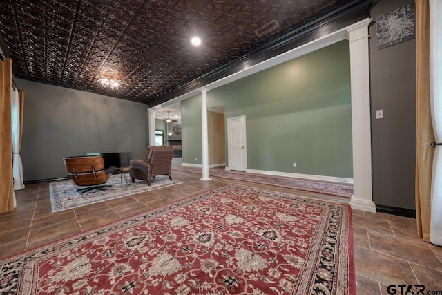 3606 Brookview Ct, Tyler, TX 75707 - living area featuring decorative columns, an ornate ceiling, stone tile floors, and crown molding