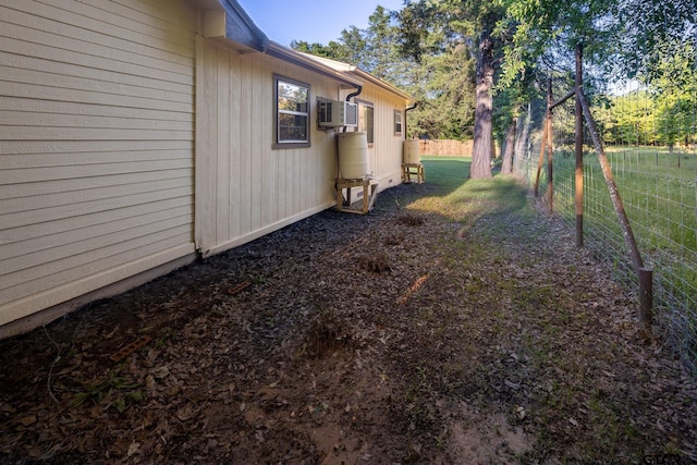 view of yard featuring an AC wall unit