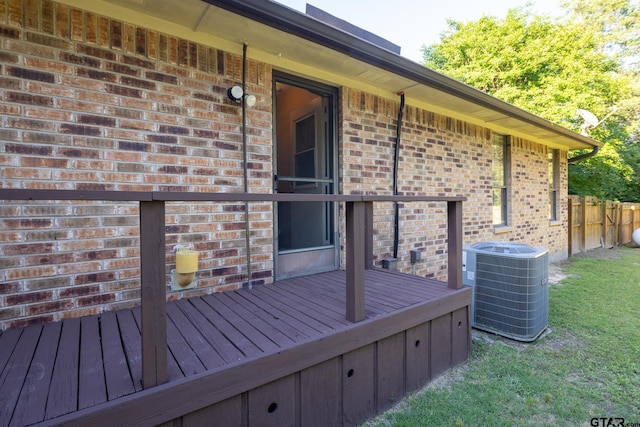 wooden deck with cooling unit and a lawn