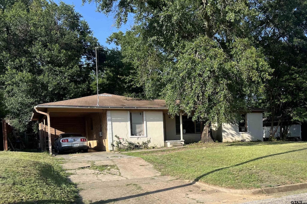 2207 Belvedere Blvd, Tyler, TX 75702 - view of front facade with concrete driveway, a front yard, and an attached carport