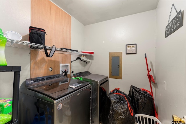 clothes washing area with electric panel and washing machine and dryer