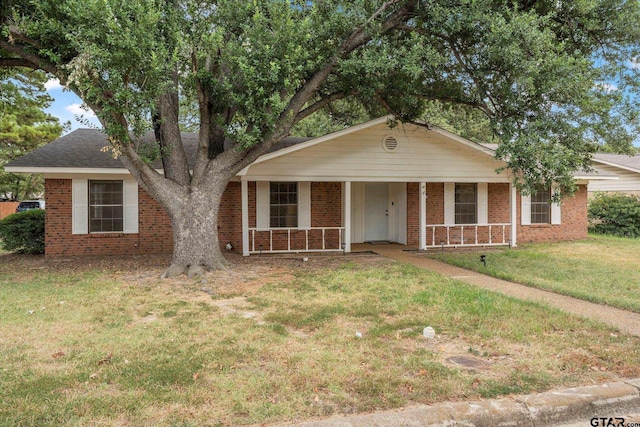 view of front of property with a front yard and covered porch