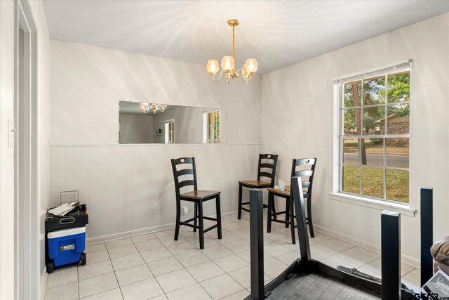 dining space featuring a chandelier, plenty of natural light, and tile patterned flooring