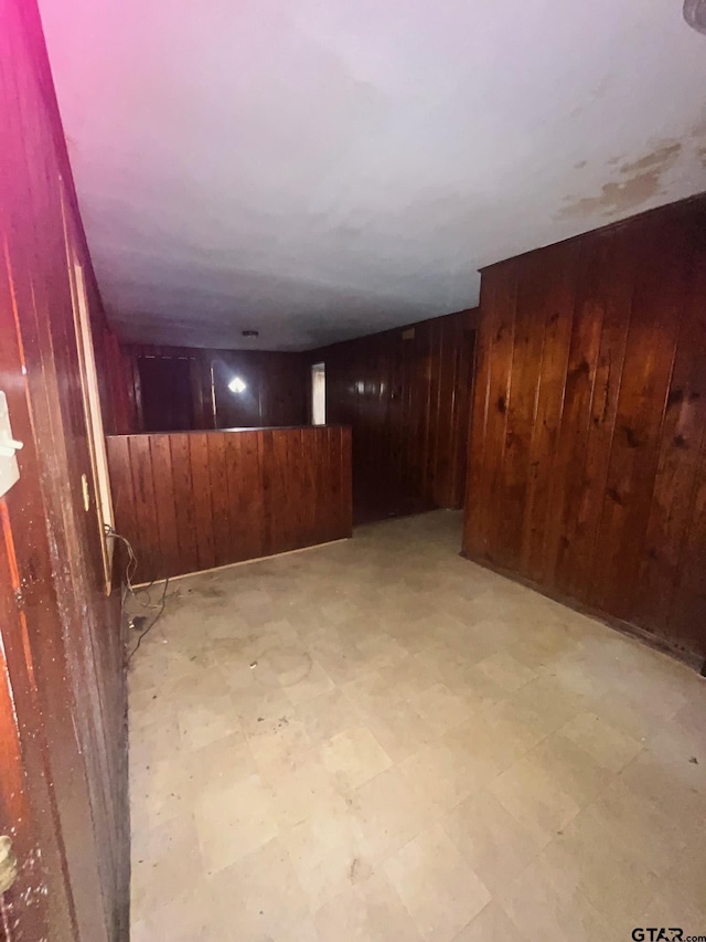 finished below grade area with wood walls and light floors