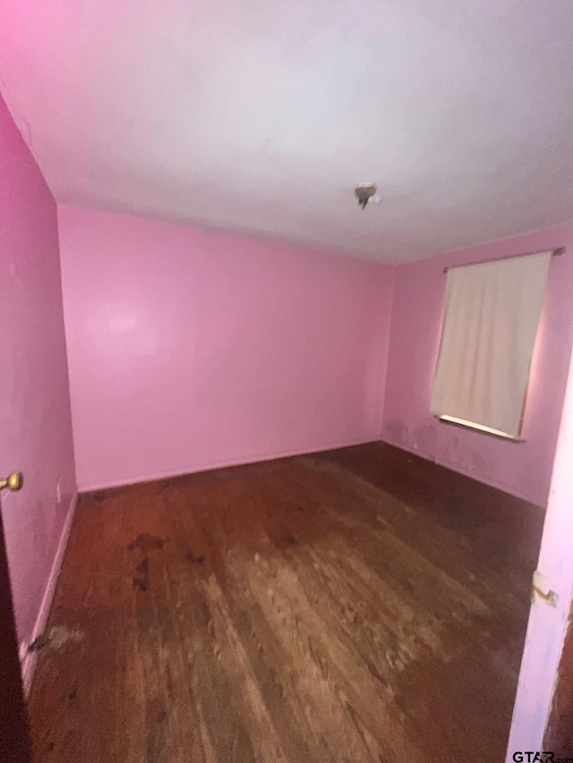spare room featuring wood finished floors