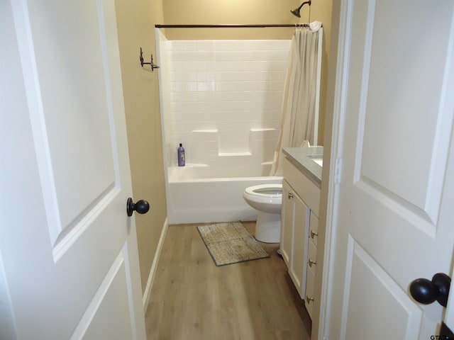 1323 Cummins St, Palestine, TX 75801 - full bath featuring wood finished floors, vanity, shower / tub combo with curtain, toilet, and baseboards