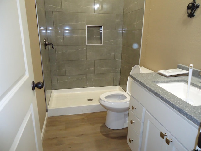 1323 Cummins St, Palestine, TX 75801 - bathroom featuring wood finished floors, toilet, vanity, and a shower stall