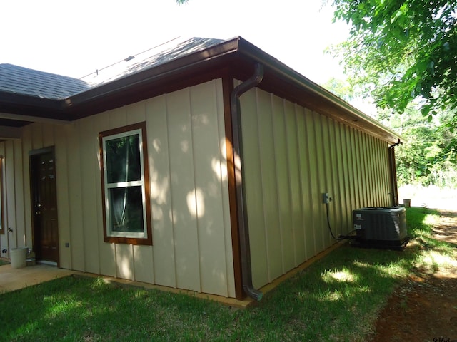1323 Cummins St, Palestine, TX 75801 - view of side of home featuring central air condition unit and board and batten siding