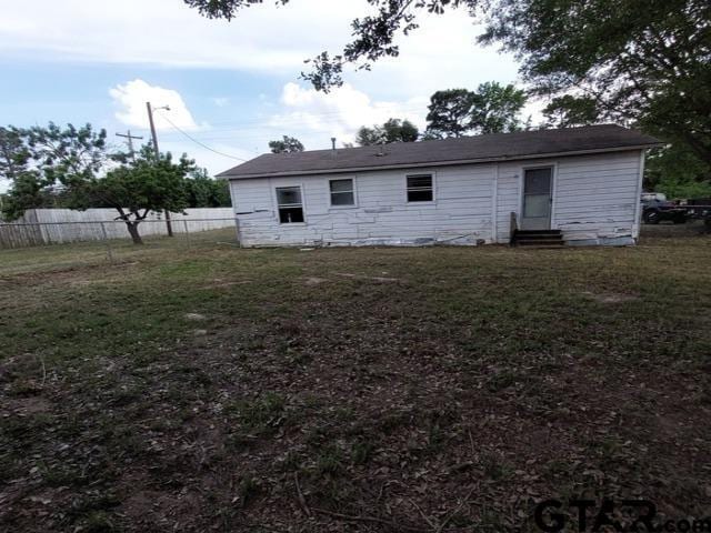 2401 E Fm 852, Winnsboro, TX 75494 - rear view of house featuring a lawn, fence, and entry steps