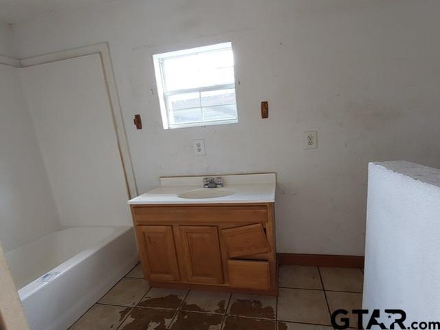 2401 E Fm 852, Winnsboro, TX 75494 - full bath featuring a tub, walk in shower, tile patterned flooring, and vanity