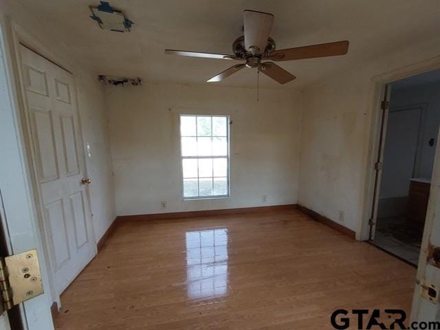2401 E Fm 852, Winnsboro, TX 75494 - unfurnished room with ceiling fan, baseboards, and light wood finished floors