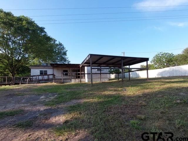 2401 E Fm 852, Winnsboro, TX 75494 - view of yard featuring fence, a carport, and a wooden deck