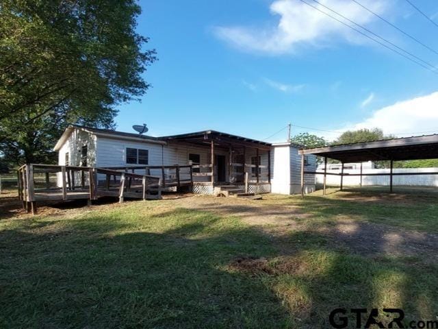 2401 E Fm 852, Winnsboro, TX 75494 - back of house featuring a lawn and a wooden deck