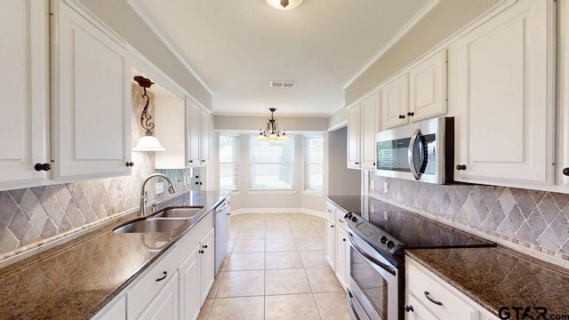 518 Meadow Creek Dr, Tyler, TX 75703 - kitchen featuring stainless steel appliances, a chandelier, white cabinetry, decorative light fixtures, and decorative backsplash