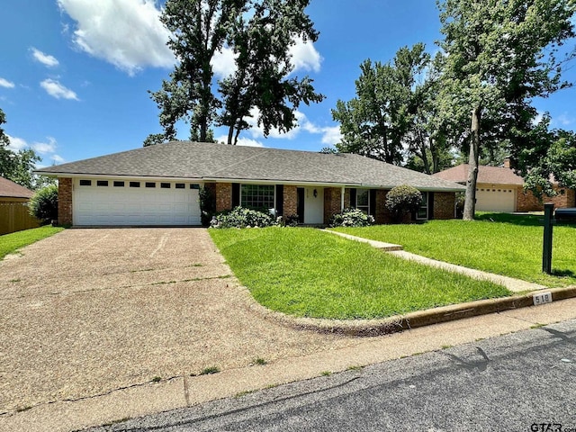 518 Meadow Creek Dr, Tyler, TX 75703 - ranch-style house featuring a garage, concrete driveway, a front lawn, and brick siding