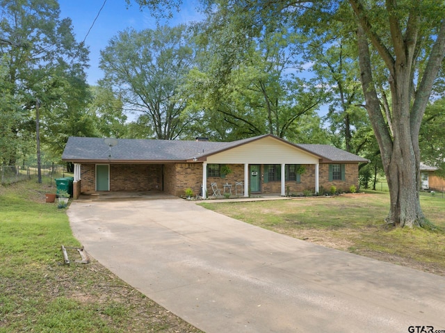 ranch-style home featuring a front yard and a carport