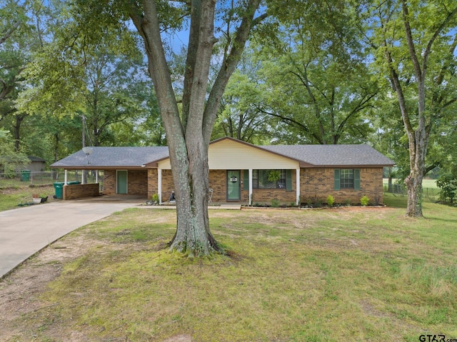 ranch-style home featuring a carport and a front lawn