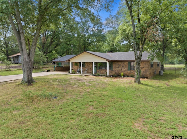 ranch-style home with a front yard and central AC