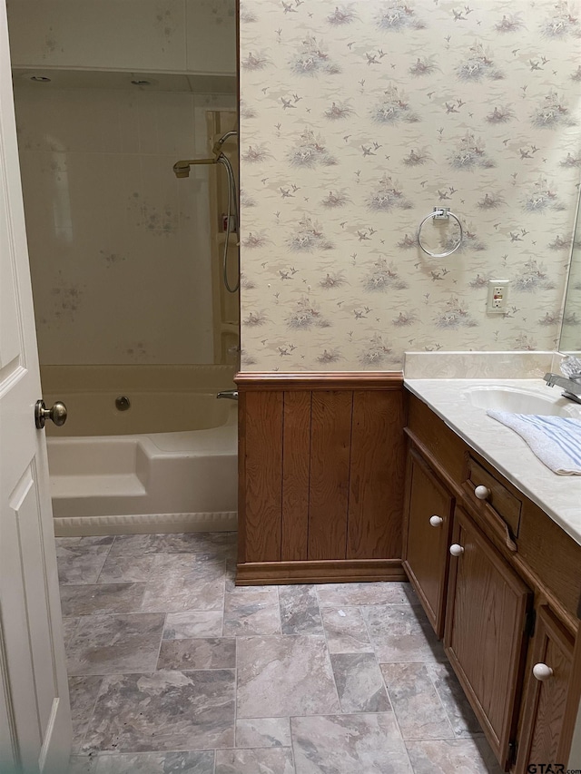 bathroom with tiled shower / bath combo and vanity