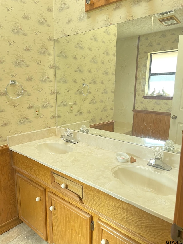 bathroom with tile patterned flooring and vanity