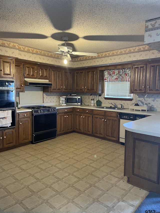 kitchen with a textured ceiling, ceiling fan, black appliances, and sink