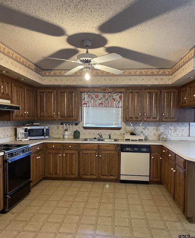 kitchen featuring sink, a textured ceiling, dishwasher, and stove