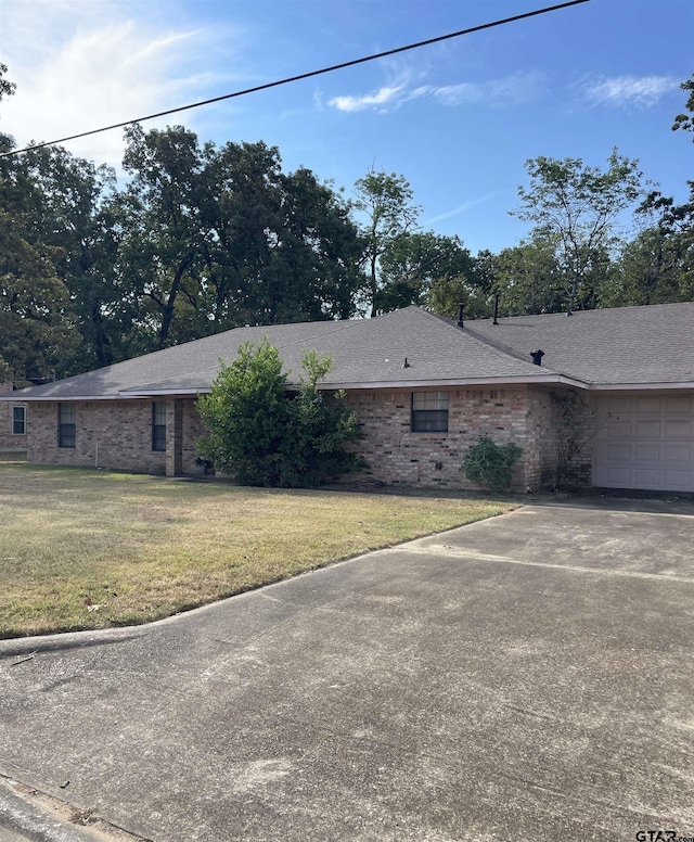 view of home's exterior with a lawn and a garage