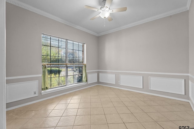 tiled spare room featuring ceiling fan and ornamental molding