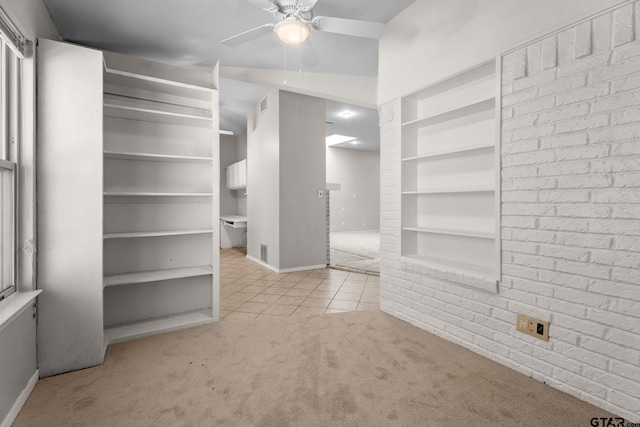 spacious closet featuring light carpet and ceiling fan