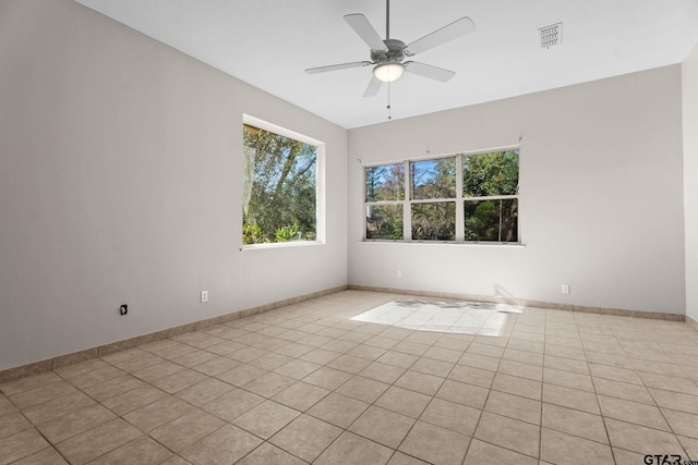 empty room featuring ceiling fan and light tile patterned floors