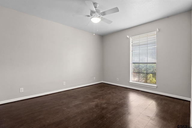 empty room featuring ceiling fan and dark hardwood / wood-style flooring