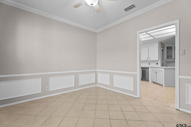 spare room with crown molding, sink, light tile patterned flooring, and ceiling fan