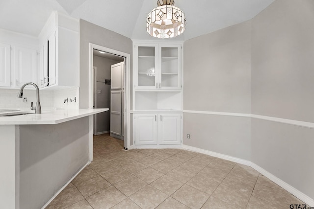 unfurnished dining area featuring light tile patterned floors, a notable chandelier, and sink