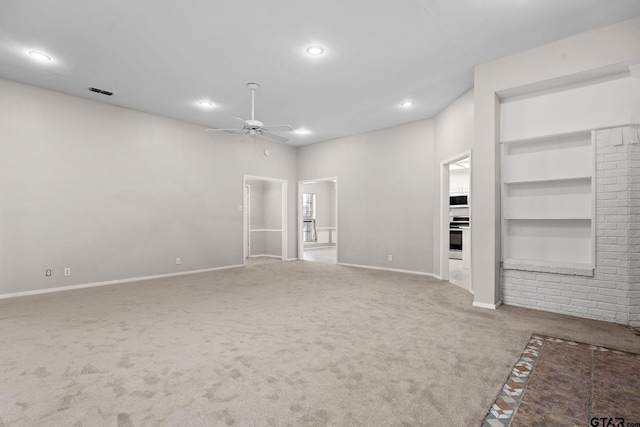 unfurnished living room featuring carpet flooring, built in features, and ceiling fan