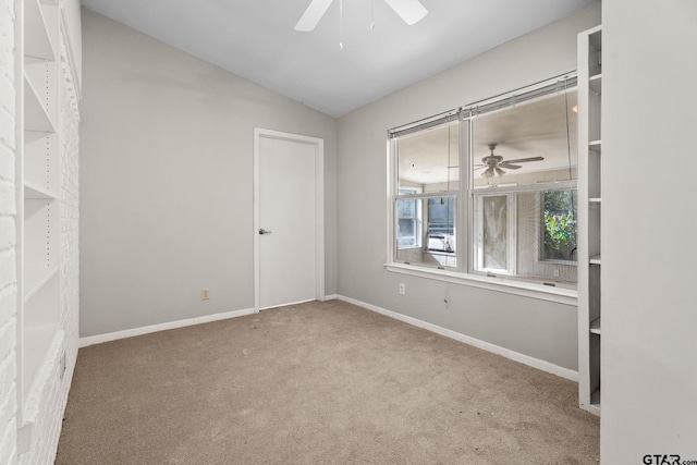 interior space with carpet floors, ceiling fan, and lofted ceiling