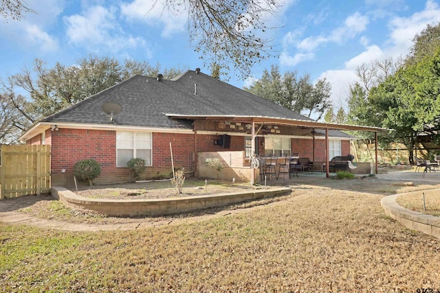 rear view of house with a patio area and a lawn