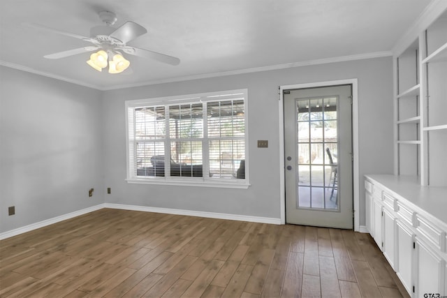 doorway to outside featuring ceiling fan, dark wood-type flooring, and ornamental molding