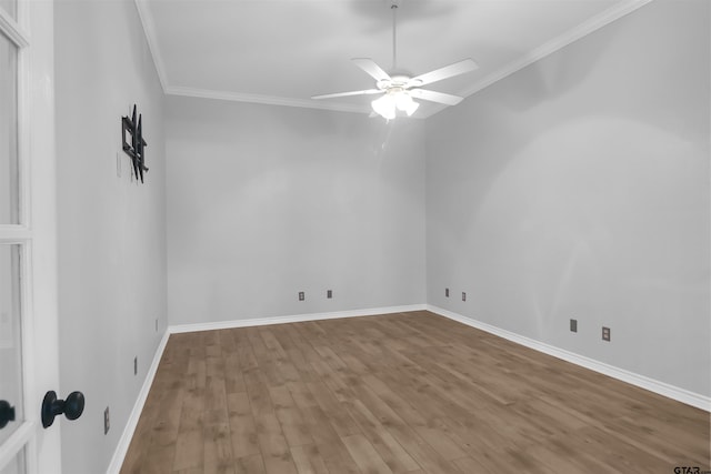 empty room with ceiling fan, crown molding, and wood-type flooring