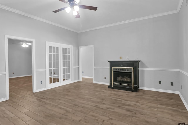 unfurnished living room featuring ceiling fan, crown molding, and wood-type flooring