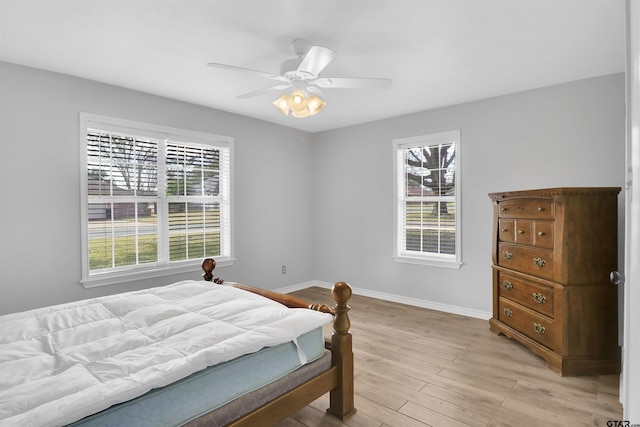 bedroom with ceiling fan and light hardwood / wood-style floors