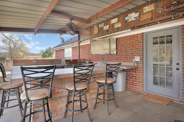 view of patio / terrace with ceiling fan, an outdoor bar, and a grill