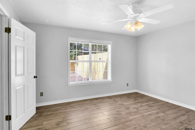 empty room featuring ceiling fan and wood-type flooring