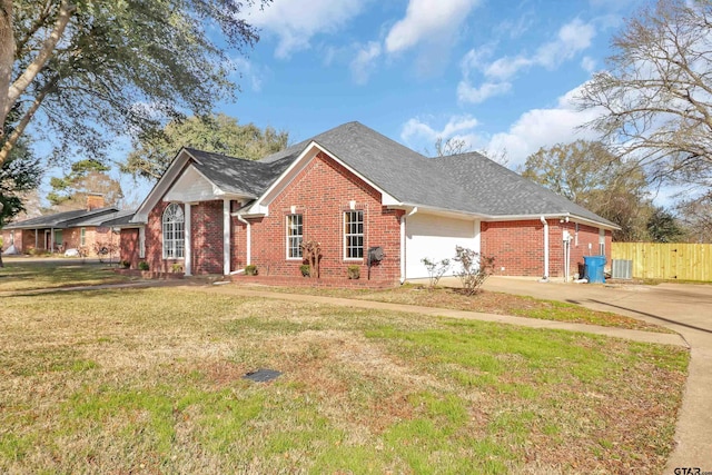 view of front of property with central AC unit, a front lawn, and a garage